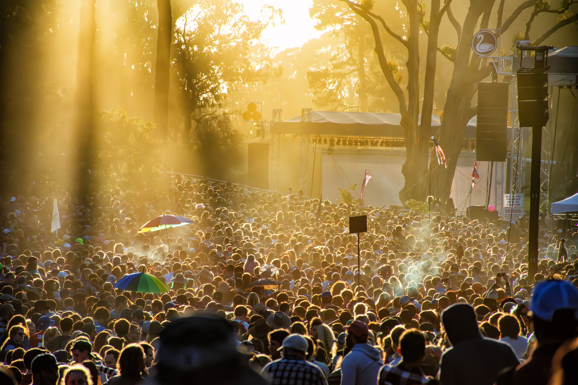 smokey crowd at music festival at sunset