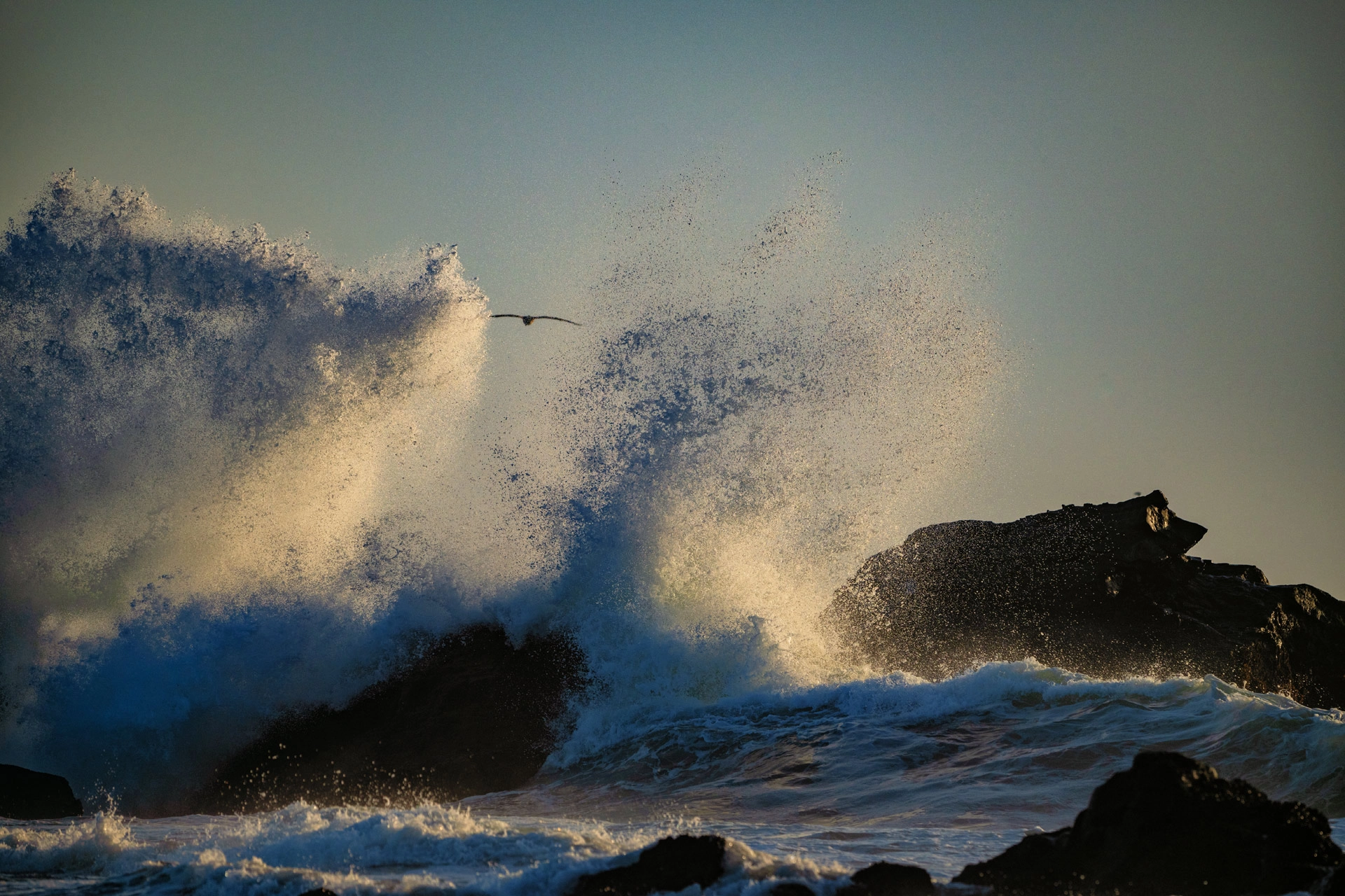 waves crashing at sunset